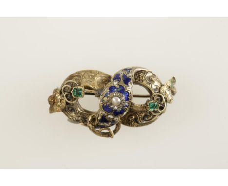 A 19TH CENTURY YELLOW METAL BROOCH of oval form, decorated with blue enamel and gem stones, c.4cm wide