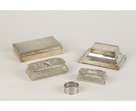 A RECTANGULAR INKWELL by Asprey & Co., Birmingham 1921, a cased napkin ring, a cigarette box and two dressing table jars, mix