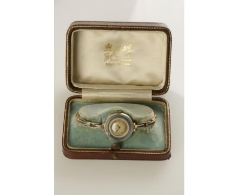 A LADIES YELLOW GOLD WRISTWATCH, the round dial with Arabic numerals surrounded by a pale blue guilloche enamel bezel, attach