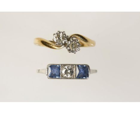 A DIAMOND DRESS RING with two illusion-set diamonds on a twisted 18ct yellow gold shank, and a sapphire and diamond dress rin