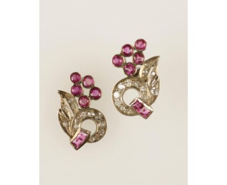 A PAIR OF DIAMOND AND RUBY EARRINGS, each pave-set circle with two princess-cut rubies flanked by pave-set leaves beneath fiv