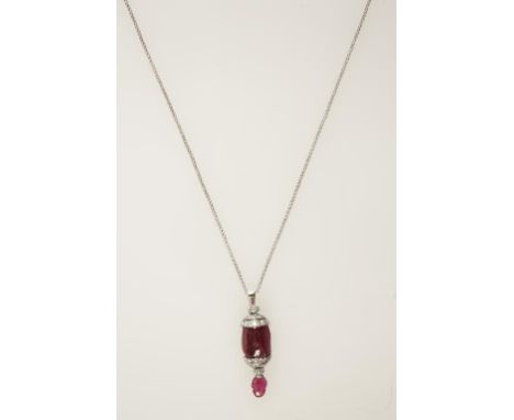 A RUBY AND DIAMOND PENDANT, the carved bead ruby c.18.18cts, the top and bottom with diamond-encrusted white metal mounts, wi