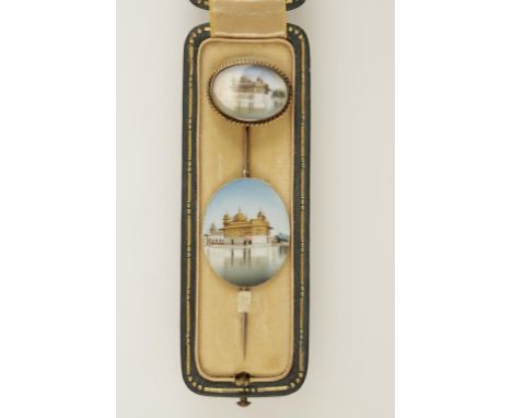 A YELLOW METAL STICK PIN, the terminal with a hand-painted ivory panel of an "Indian Temple", in a fitted "Dreicer & Co. New 