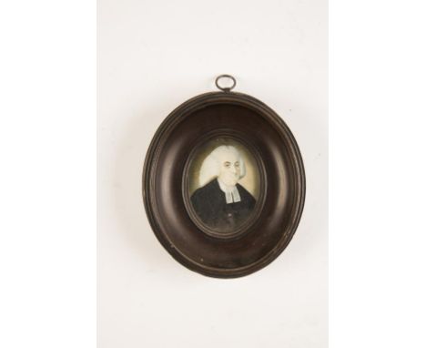 AN OVAL PAINTED PORTRAIT MINIATURE, 19th century, of a Wesleyan Preacher, wearing a black gown with white collar, in a turned