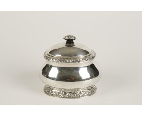 A GERMAN TEA CADDY of oval form with a domed hinged lid, with foliate scroll borders and gilded interior, the base stamped wi