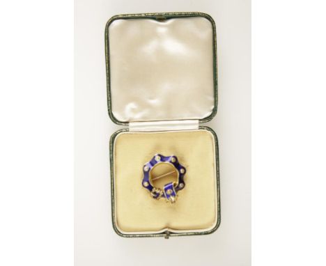 AN ENAMEL AND PEARL BUCKLE BROOCH, the blue enamel set with seven seed pearls, with gilt metal buckle and drape, set on unmar