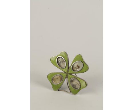 A CONTINENTAL SILVER AND ENAMEL PHOTOGRAPH FRAME in the form of a four leaf clover, with green guilloche enamel leaves inset 