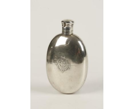 A VICTORIAN HIP FLASK of oval form with a pull-off cup, monogrammed, by Thomas Johnson, London 1877, 5.25" long (c.6.2oz)