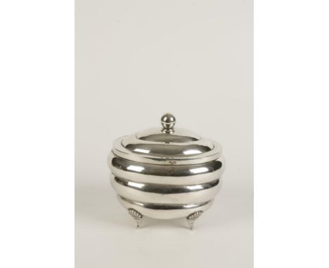 A CONTINENTAL TEA CADDY of ribbed oval form, the hinged cover with ball finial, the whole on four shell-capped bracket feet, 