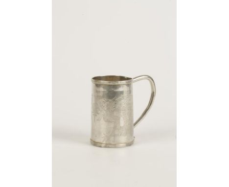 A CHINESE MUG of circular form with reeded borders, scroll tubular handle, the body engraved with dragons and characters, sin
