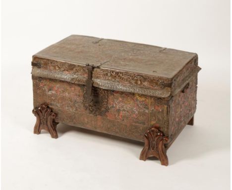 AN HISPANIC EMBOSSED LEATHER TRAVELLING TRUNK of rectangular form, all-over covered in foliate and bird decoration with strap