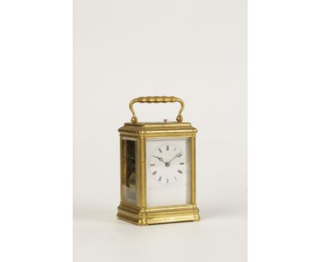 A FRENCH GILT BRASS REPEATING CARRIAGE CLOCK, the white enamel dial with Roman numerals, striking on a bell, in a gorge case,