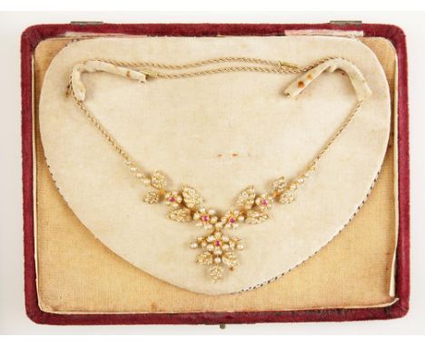AN EDWARDIAN RUBY AND PEARL NECKLACE with sprays of flowers and foliage, set on 18ct yellow gold, attached to an unmarked yel