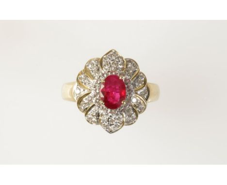 A RUBY & DIAMOND CLUSTER RING, the oval-cut ruby c.0.75cts surrounded by a cluster of brilliant-cut and pave-set diamonds, c.