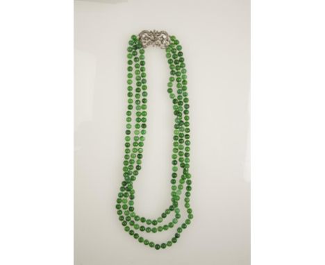 A THREE STRAND JADE AND DIAMOND NECKLACE, each jade c.1.52cts (c.313cts total), (c.74.6grams) terminating in a diamond openwo