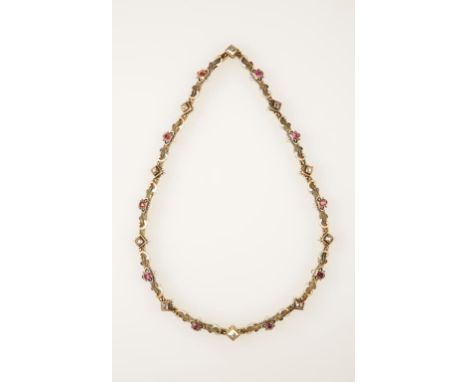 A HOLBEINESQUE GEM SET AND ENAMEL NECKLACE set with rubies and diamonds interspersed with panels of scroll work picked out in