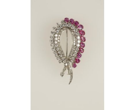 A RUBY AND DIAMOND BROOCH, the claw-set and pave-set diamonds c.5.10cts, with an outer border of eleven pear-cut natural coru