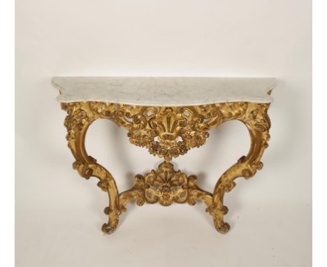 A ROCOCO STYLE GILTWOOD AND MARBLE CONSOLE TABLE, the serpentine fronted white marble top with moulded border, on two scrolli