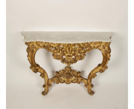 A ROCOCO STYLE GILTWOOD AND MARBLE CONSOLE TABLE, the serpentine fronted white marble top with moulded border, on two scrolli