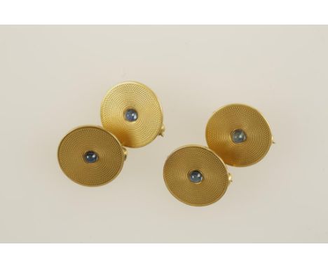 A SET OF FOUR YELLOW GOLD DRESS CLIPS, each one engine-turned with a central cabochon blue stone, the reverse marked "14 kara