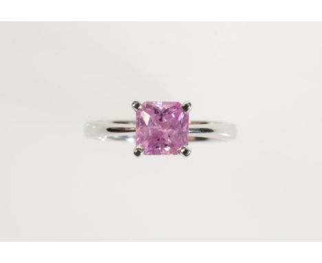 A PINK SAPPHIRE DRESS RING, the square-cut sapphire claw-set on a white gold shank marked "750" (ring size K)