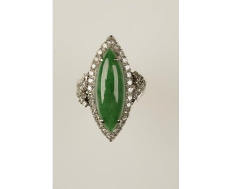 A JADEITE AND DIAMOND DRESS RING, the lozenge-shaped jadeite surrounded by a border of round-cut diamonds, on a white metal s