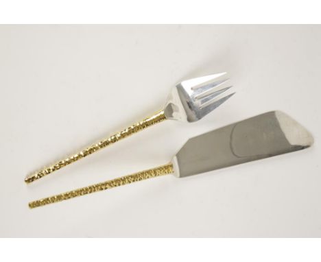 STUART DEVLIN: A PAIR OF PARCEL GILT FISH SERVERS with textured handles, London, 1968, 12" long. See illustration