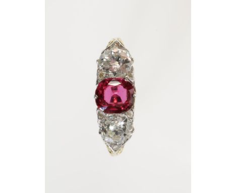 A RUBY AND DIAMOND THREE STONE DRESS RING, the central ruby c.1.12cts, flanked by two diamonds totalling c.1.60cts, on an unm