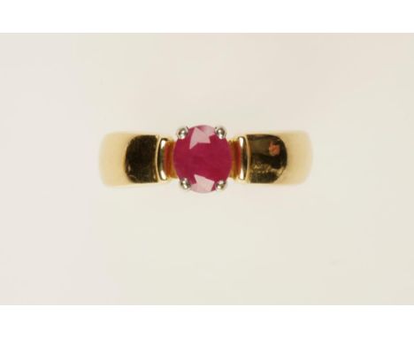 A RUBY DRESS RING claw-set in white metal on an 18k yellow gold band (ring size N). See illustration