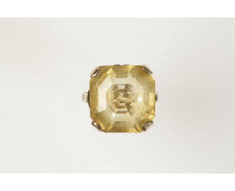 A GEM-SET DRESS RING, the square-cut gemstone claw-set in a raised setting, on an unmarked yellow metal shank (ring size K)