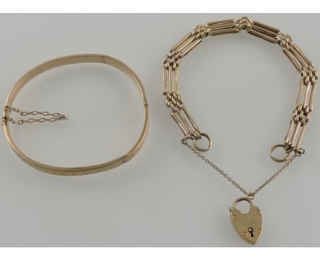 A 9 carat yellow gold gatelink bracelet with padlock clasp together with a 9 carat rose gold engraved hinged bangle 16.5 gms