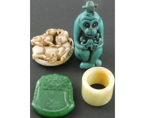 A Chinese style carved hardstone pendant together with an onyx thumb ring, a scent bottle modelled as a monkey and a pierced 