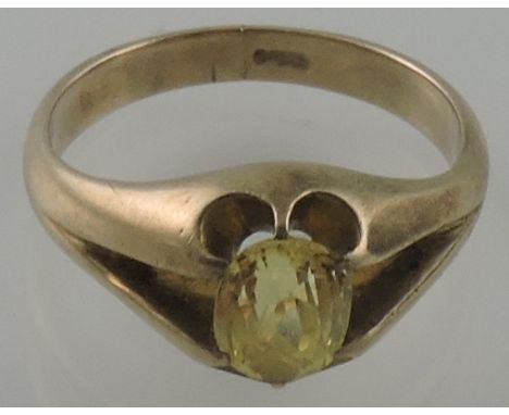 A yellow sapphire dress ring, the oval faceted stone claw set in a 9 carat band