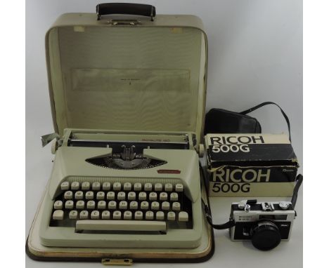 A boxed Ricoh 500G 35mm camera together with a Royal portable typewriter