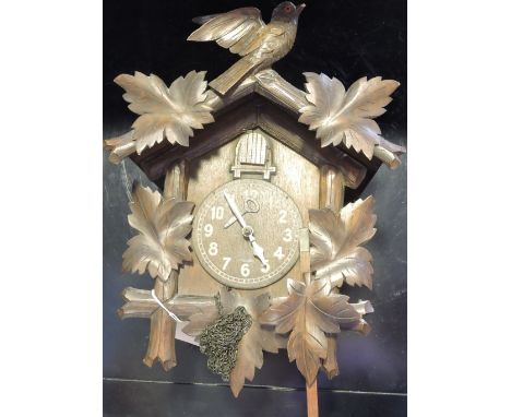 A Black Forest style carved beech and pine cuckoo clock 