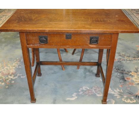 An early 20th Century Arts and Crafts oak side table fitted drawer on square tapered legs, W.100 cms (bears Manchester retail