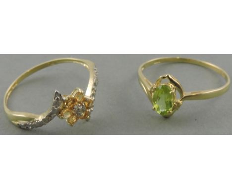 A 9ct gold peridot and diamond ring together with a 9ct gold citrine and diamond plum blossom ring