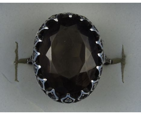A smoke quartz dress ring, with a white metal settings on a yellow metal band stamped 9ct. 
