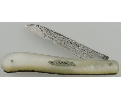  A late Victorian mother of pearl handled fruit knife with an engraved silver blade, Birmingham 1900