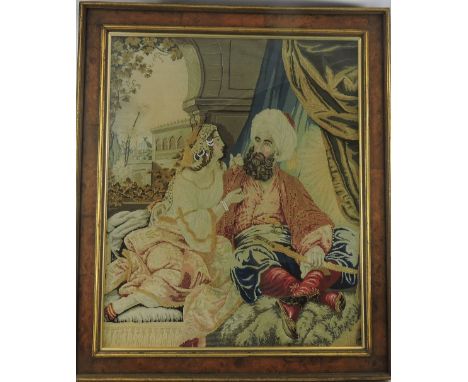 A 19th Century Berlin polychrome tapestry panel depicting a Persian couple within a palace interior, burr walnut and parcel g