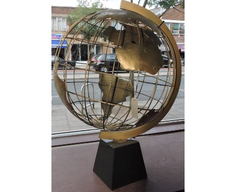 A large decorative gold painted wrought iron globe on tapered ebonised plinth, H:136cm