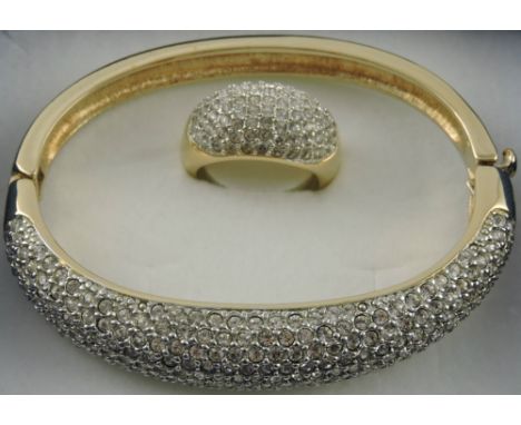 A Noemi Swarovski crystal bangle, pave set in a gold plated band, en suite with a ring, (2).