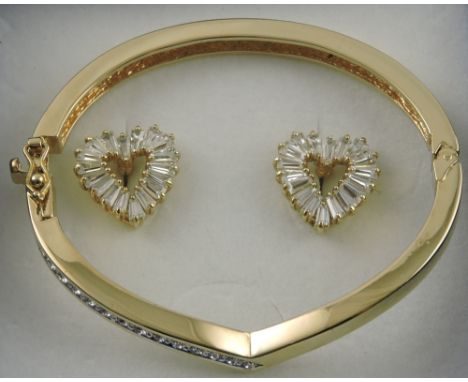 A Swarovski crystal gold plated bangle with a pair of heart shaped ear studs, (2).