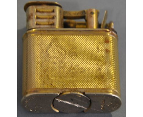 A Dunhill 9ct gold lift arm petrol lighter, with engine turned body. Marks for 1929, Patent No. 143752. 