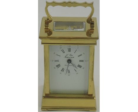 A 20th century brass carriage timepiece, the white enamel dial with Roman numerals in a corniche case, H.13cm.