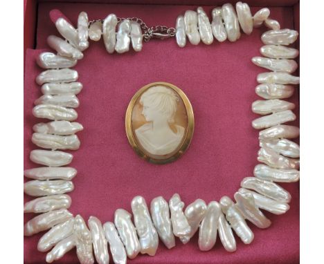 A gold cameo brooch with a young female portrait and a boxed Pia Jewellery necklace formed with irregular patterned freshwate