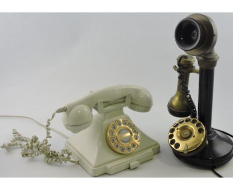 A vintage style candlestick telephone together with a GPO style pushbutton telephone.