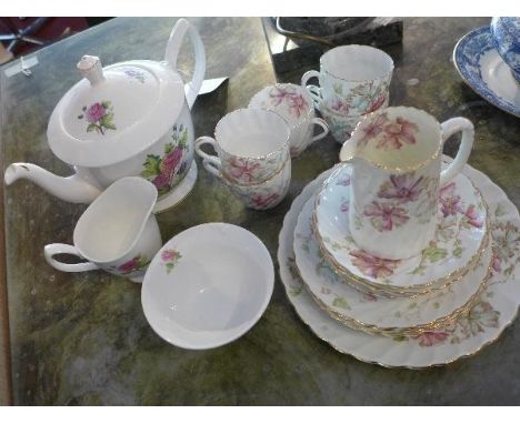 A Royal Albert three piece tea set, teapot, jug and bowl, flower of the month pattern 'Chrysanthemum', together with an Aynsl