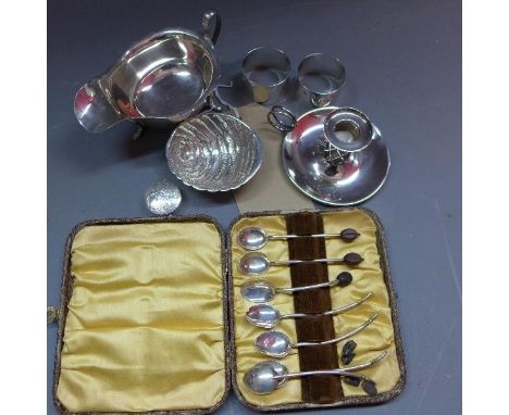 A miscellaneous collection of silver to include, a gravy boat, danish silver chamber stick by hingelberg aarhus, two napkin r