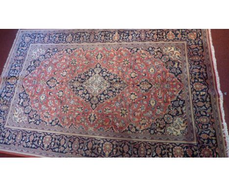 An extremely fine Central Persian Kurk Kashan rug, 220cm x 142cm, the central medallion on a light red field with repeating s